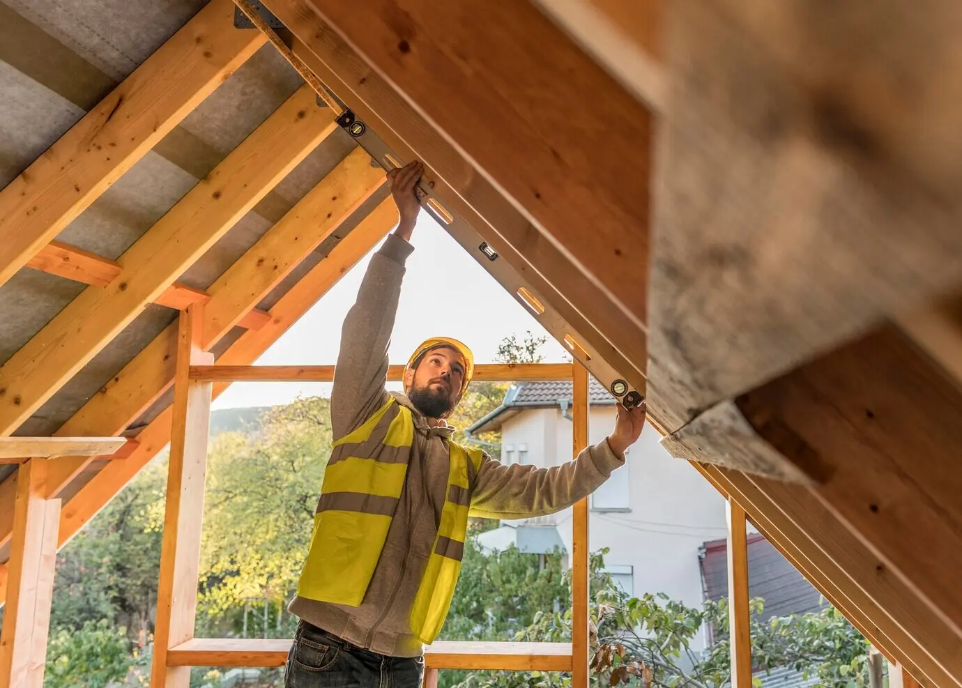 A male carpenter working on a roof