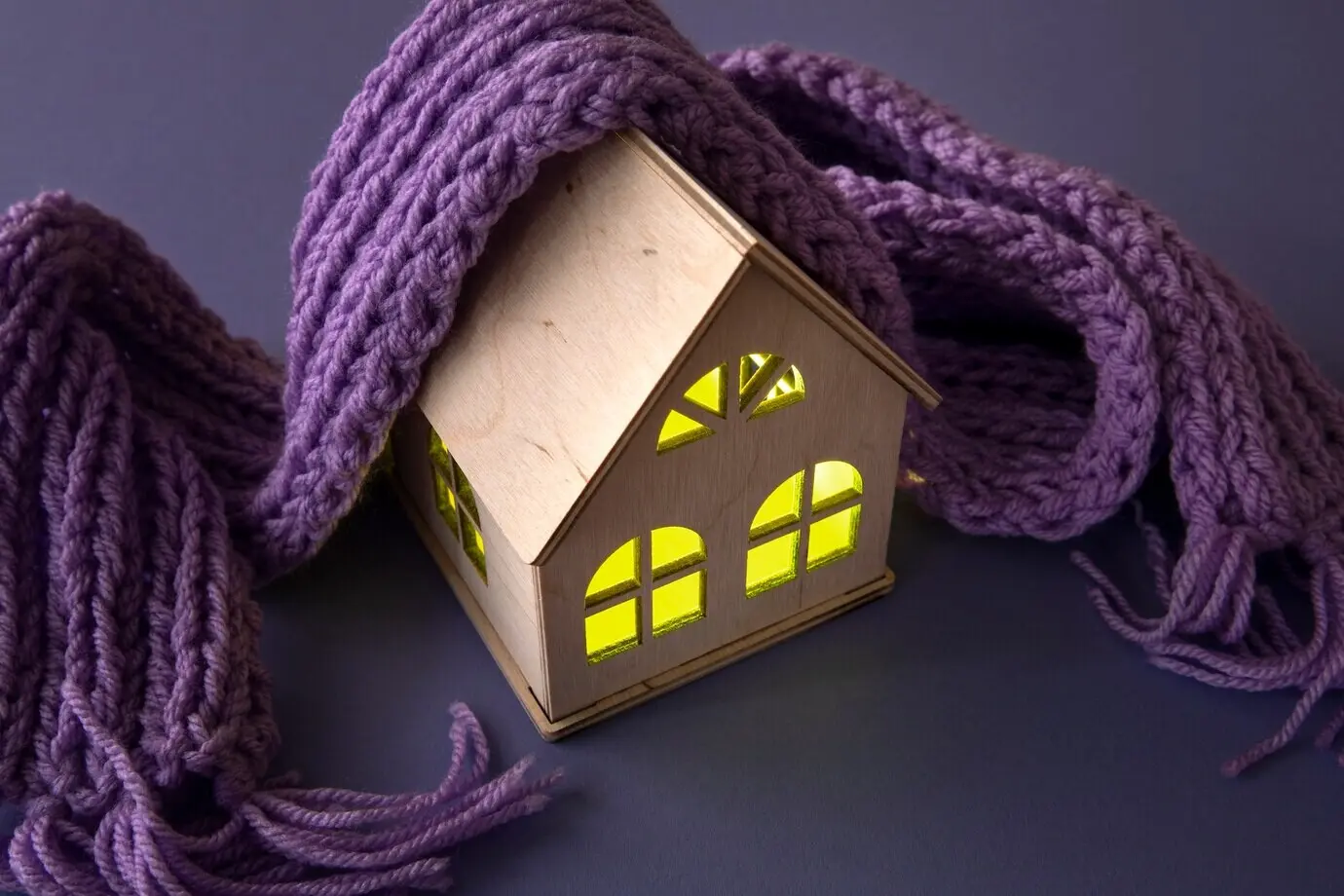 A cozy home concept featuring a wooden toy house.